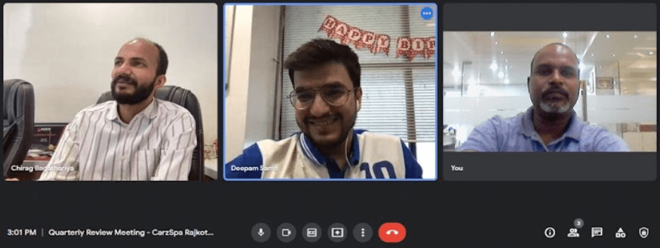A screengrab of a Zoom meeting with three people smiling