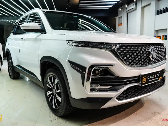 A white MG Hector parked inside the detailing bay of a car detailing studio in India