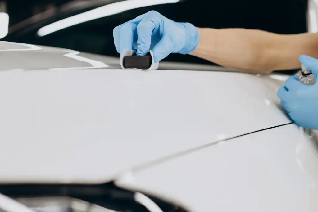 A white car in the process of being ceramic-coated