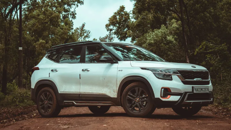 A white coloured SUV parked on a dusty trail