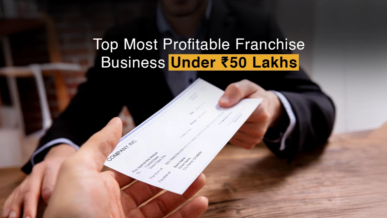 A man hands over a cheque across the table