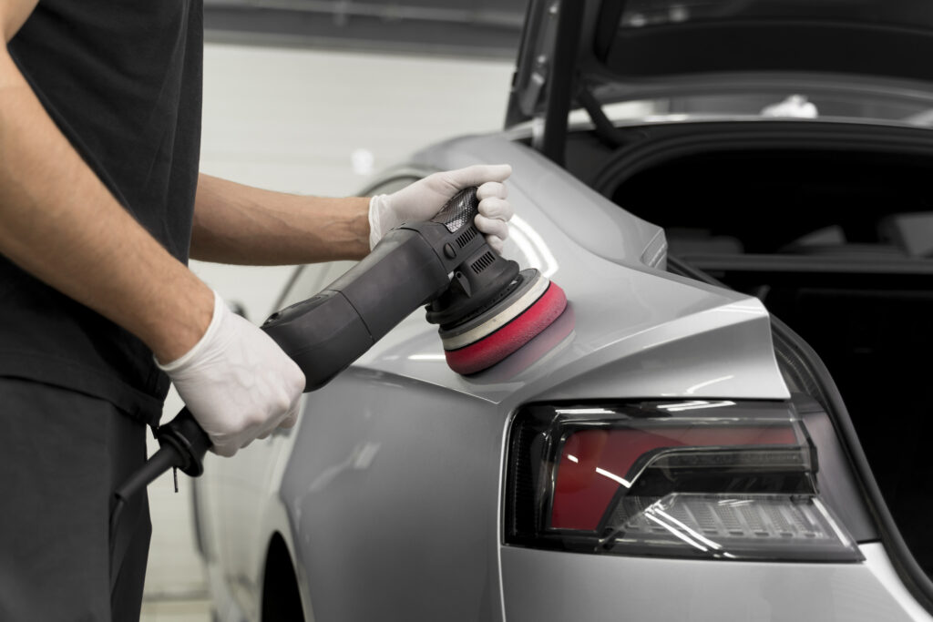 Close-up of a grey coloured sedan being polished for car detailing