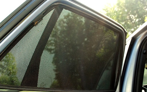 A car window protected with car sunshade