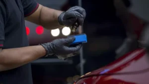A CarzSpa detailer applying a ceramic coating to a luxury car, illustrating the evolution of car detailing in India.