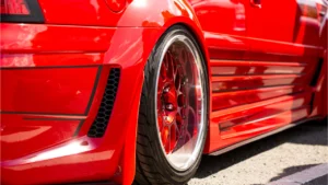 Rear-view of the wheel of a red coloured modified car