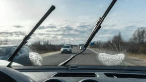 Crystal clear car windshield with water beading effect showing optimal visibility during monsoon driving
