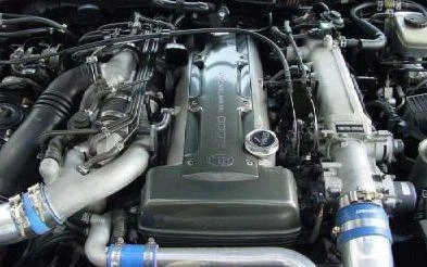Toyota 2JZ-GTE engine bay showcasing the iconic inline-six configuration and turbo setup