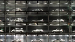A panoramic view of a Mercedes-Benz showroom in Munich, Germany, with multiple luxury cars visible