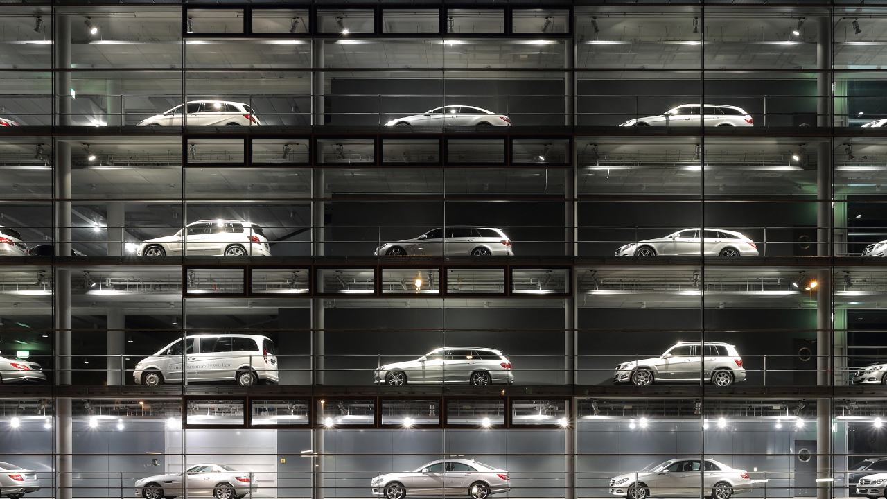 A panoramic view of a Mercedes-Benz showroom in Munich, Germany, with multiple luxury cars visible