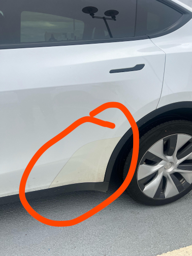 Yellow tint on the bottom panel of a white sedan