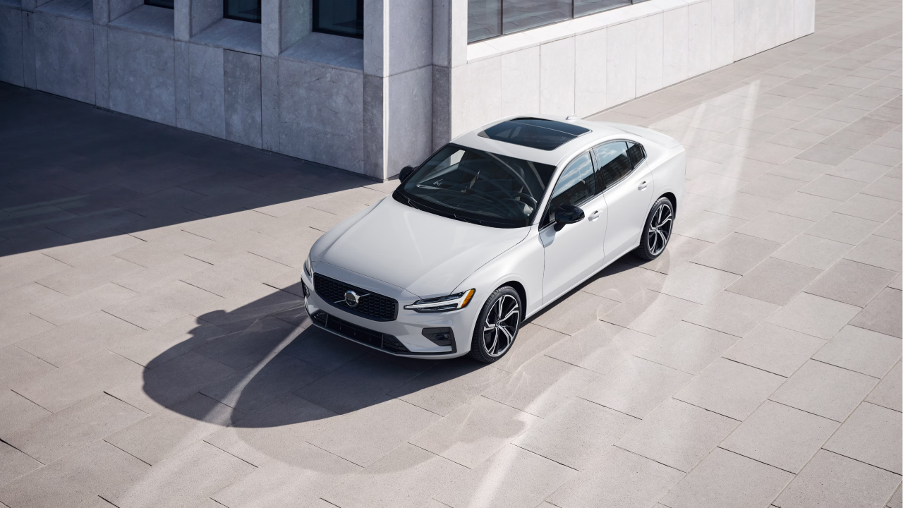 A shiny white Volvo S60 photographed in an outdoor setting