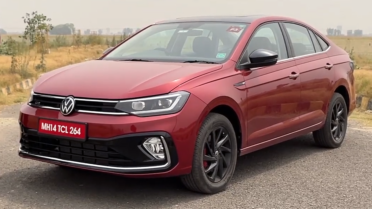 A striking red Volkswagen Virtus in an outdoor setting, highlighting its elegant lines and glossy finish, which is ideal for a professional PPF application.