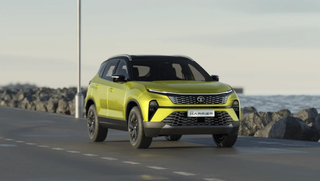 A sunlit green Tata Harrier driving on a coastal road somewhere in India