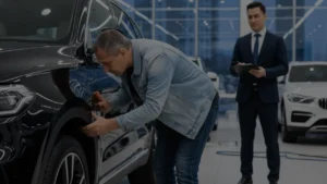 Car buyer carefully examining a new car's condition during pre-delivery inspection at the showroom