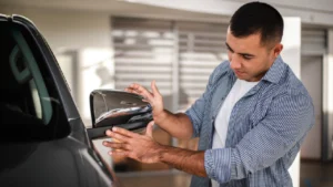 A person reviewing his new car at a car dealership.