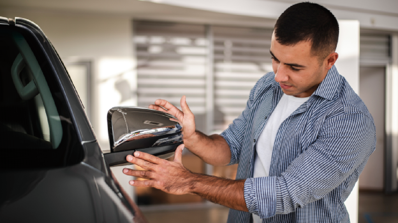 A person reviewing his new car at a car dealership.