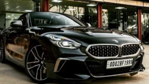 A black BMW sedan parked outside a CarzSpa Detailing Studios