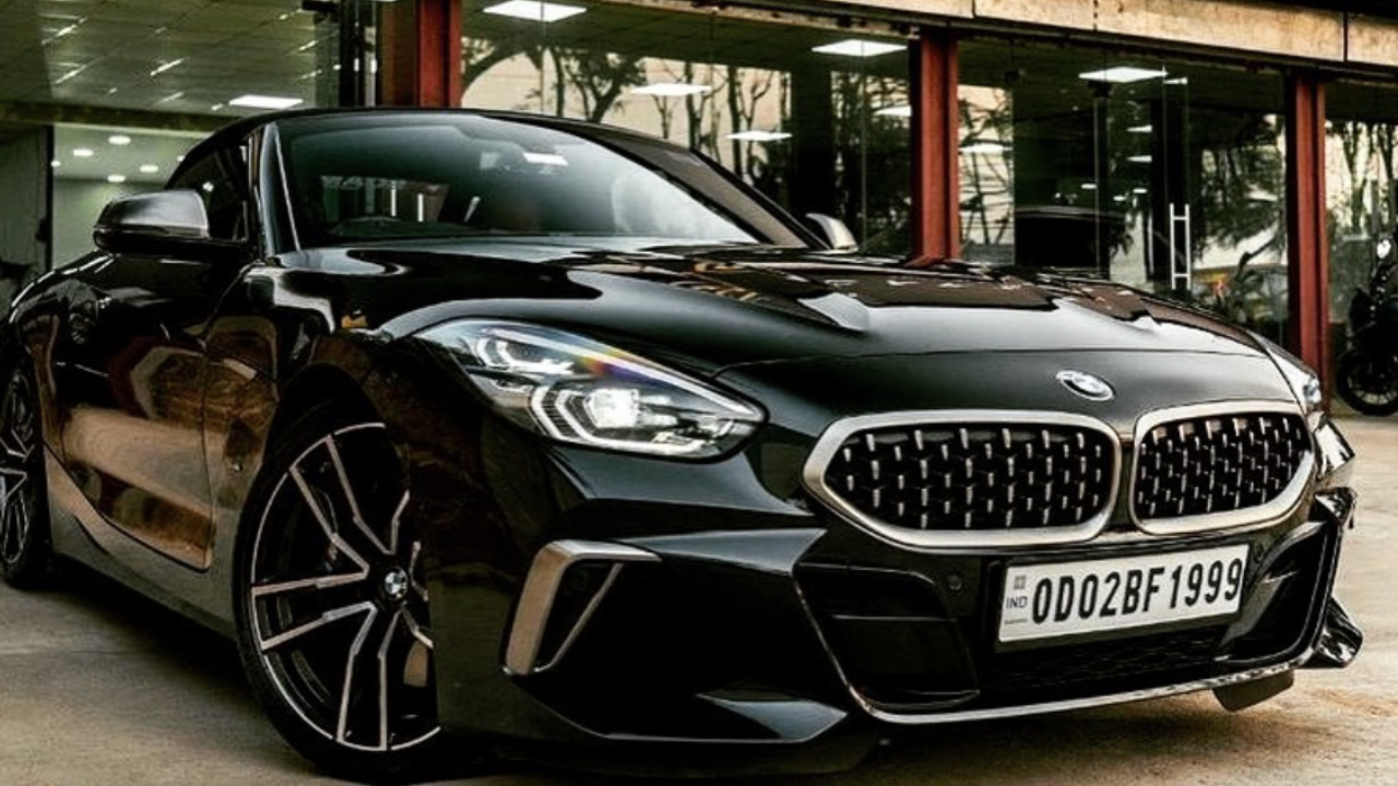 A black BMW sedan parked outside a CarzSpa Detailing Studios