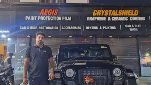 A man stands next to his Mahindra Thar