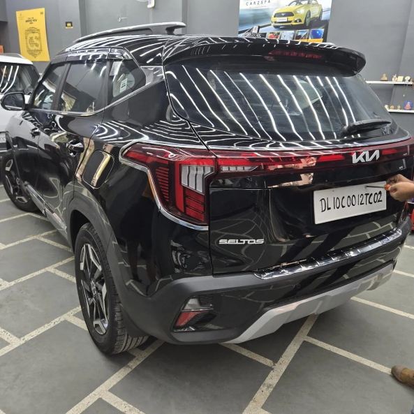 A black Fortuner parked inside a detailing studio