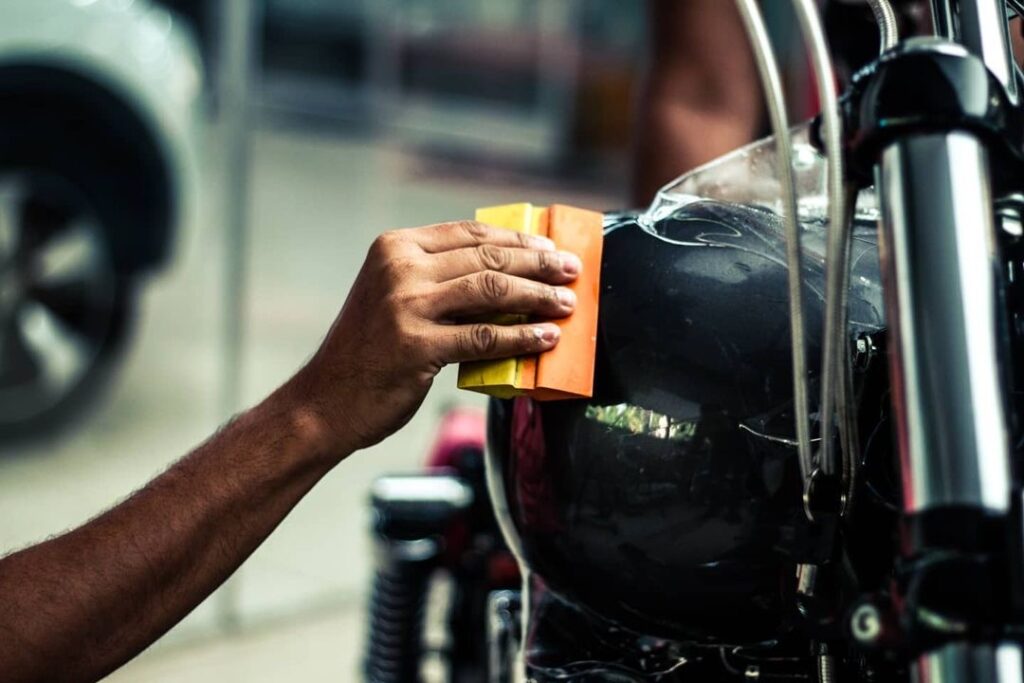 Close-up shot of a clear film being installed on the rear-view mirror of the car