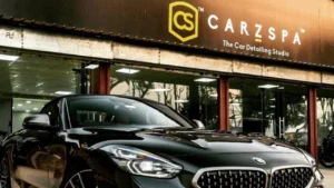 A black BMW parked outside a CarzSpa Detailing Studio