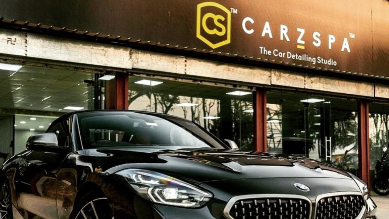 A black BMW parked outside a CarzSpa Detailing Studio