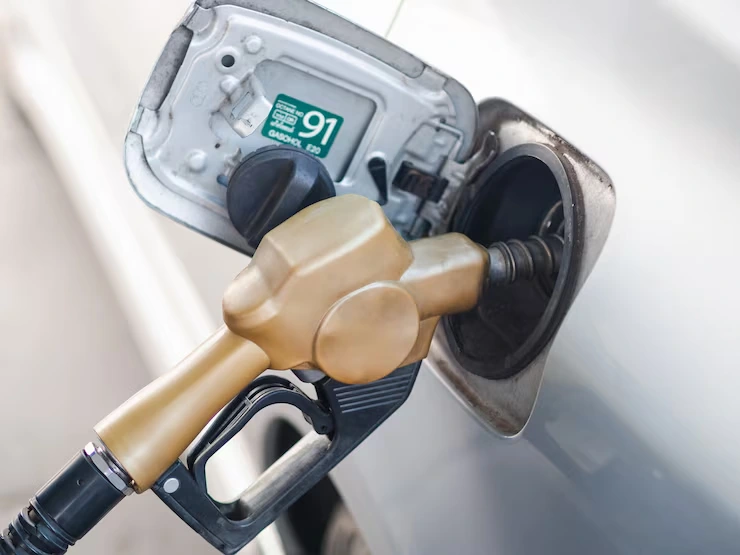 A fuel nozzle inside the fuel tank opening of a car