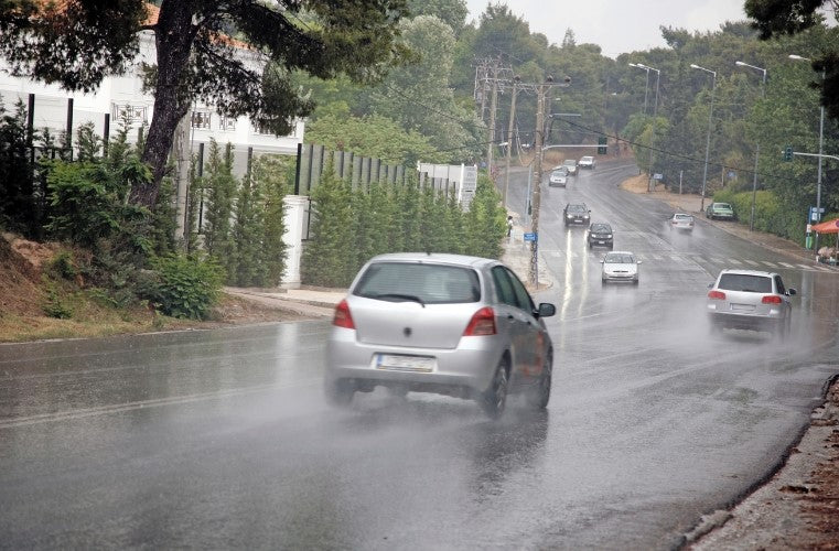 cars driving through rain in India