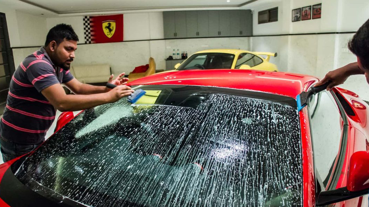A sleek red SUV protected with Aegis hydrophobic PPF shows water beading and dirt-repellency.