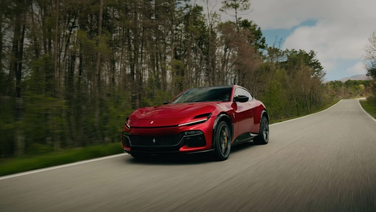 A Ferrari Purosangue drives through a country road