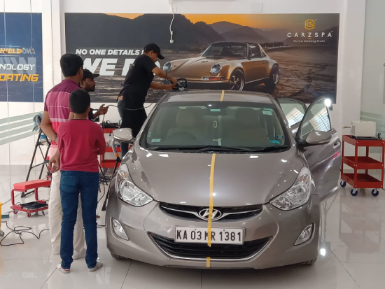 A car detailing franchise owner reviewing studio operations with his team