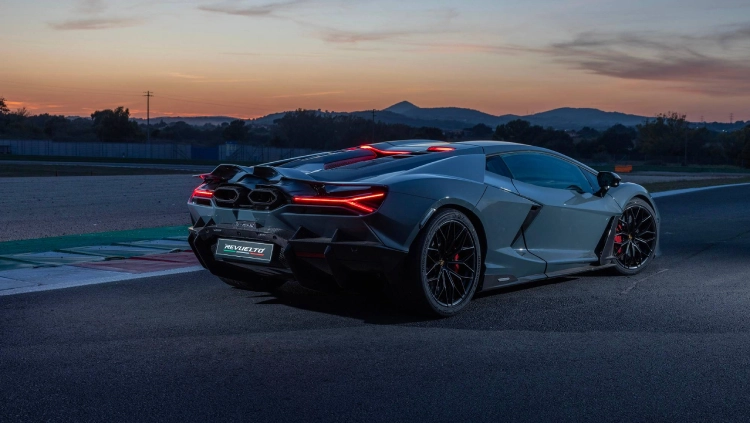 A Lamborghini Revuelto drives on the kerb of a race track