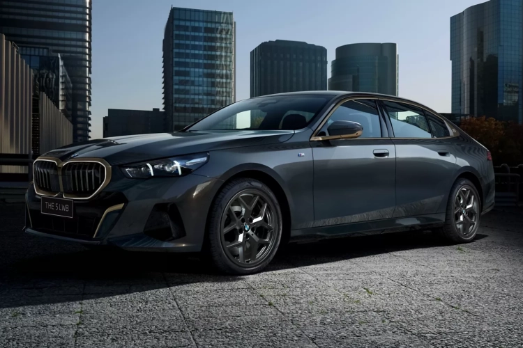 Black BMW 5 Series parked outside a building complex