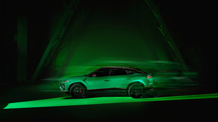 A green coloured Lamborghini Urus SE drives past an enclosed space