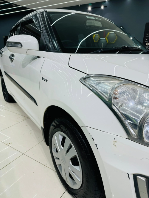 Scratches on the front fender of a white car