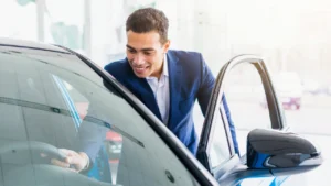 A car buyer checking out a new car inside a dealership
