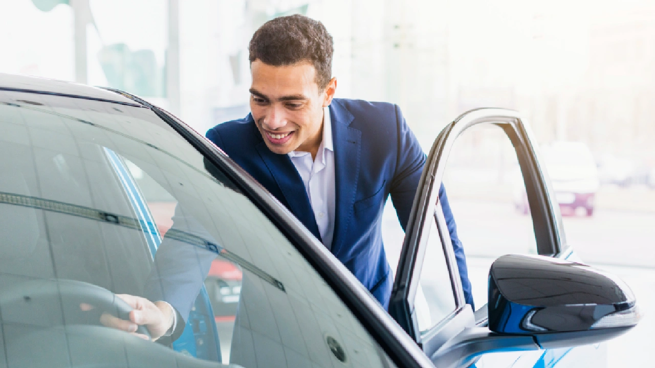 A car buyer checking out a new car inside a dealership