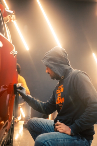 A worker applies ceramic coating on a car