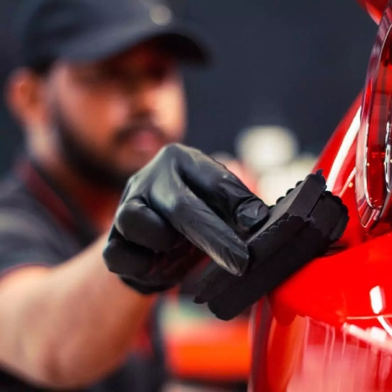 A worker applies ceramic coating on a car