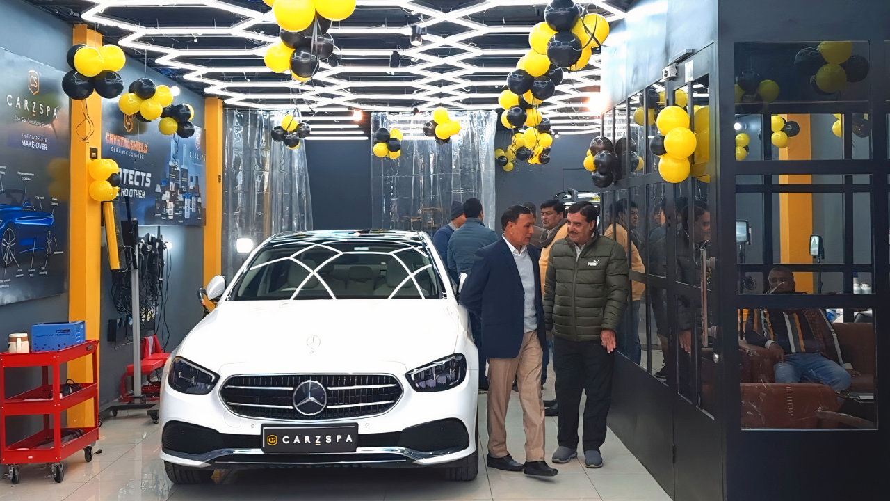 A few people inspecting a newly set up car detailing studio