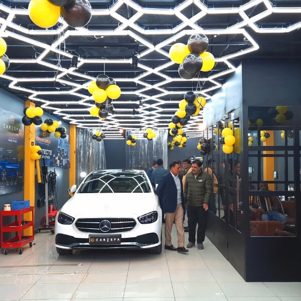 People checking out a brand new car detailing studio from the inside