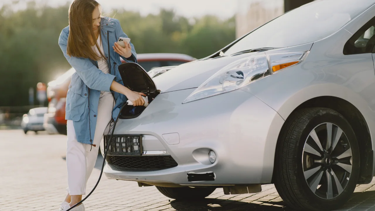 Electric car charging at a public EV charging station in India