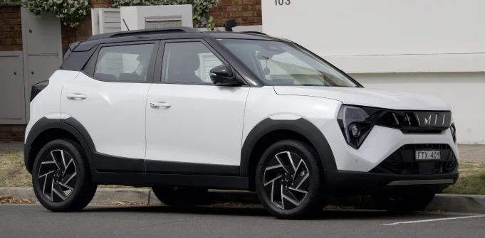 A white Mahindra XUV 3XO parked on the kerbside of a street