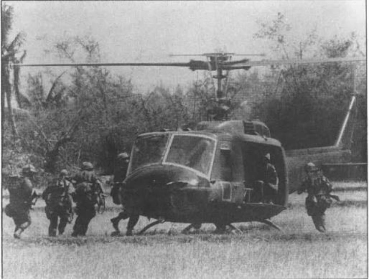 An old black and white image of militants getting down from a chopper.