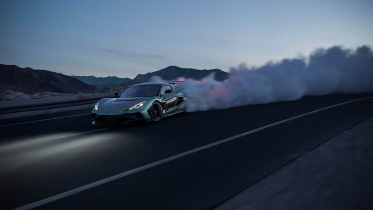 A Rimac Nevera R speeds through a plume of smoke on a road