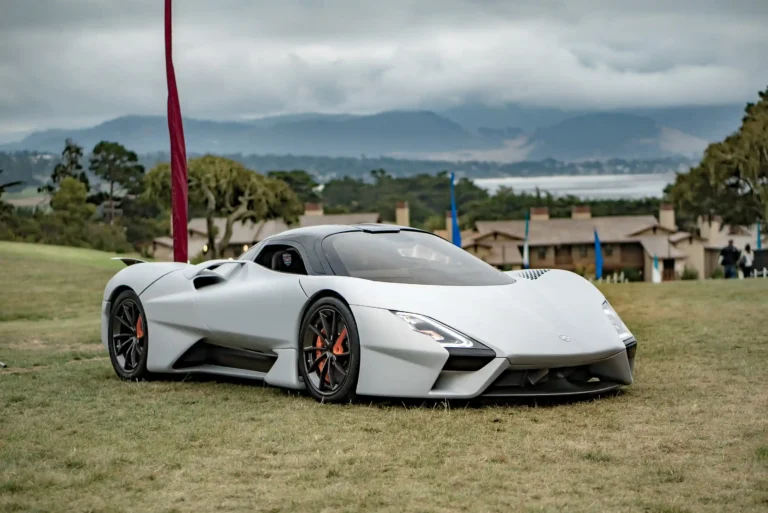 A grey SSC Tuatara parked on a grassy plain
