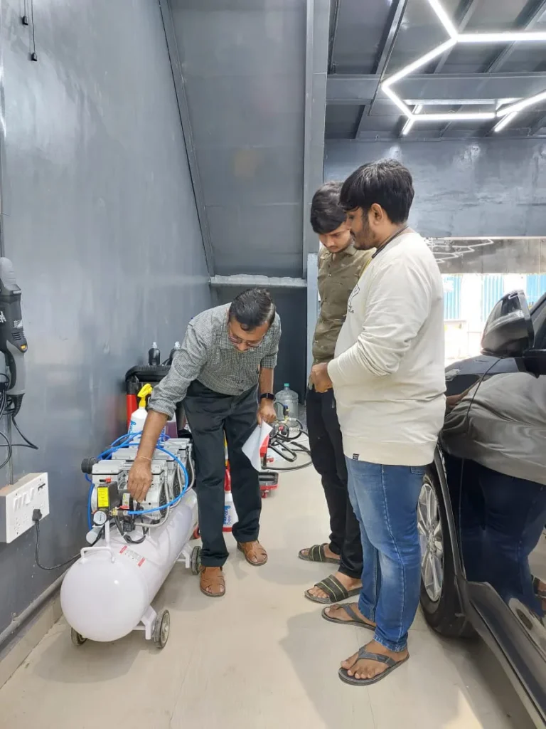 A man explains the working of a machine to two individuals