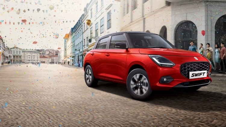 A concept image of a red Maruti Suzuki Swift on a streetside