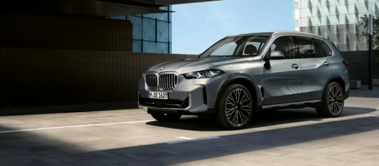 A BMW X5 parked in slightly shaded area